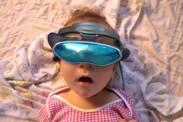 Baby wearing virtual reality goggles